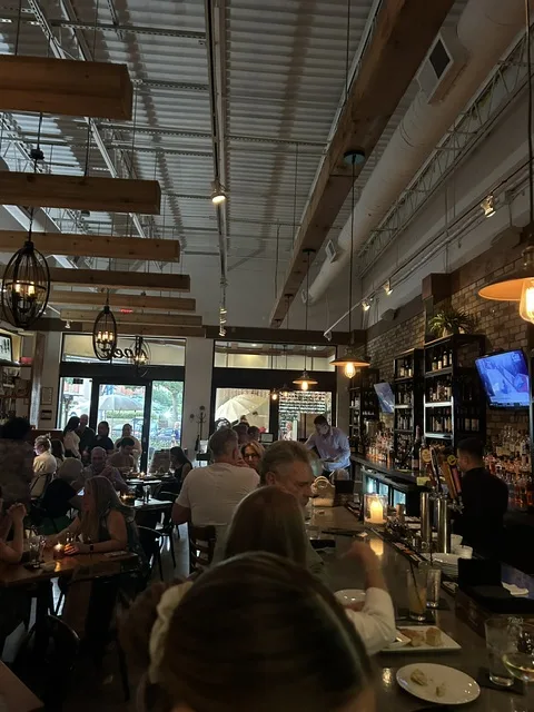 Pane Vino dining room packed on a Friday night — warm brick walls and full bar